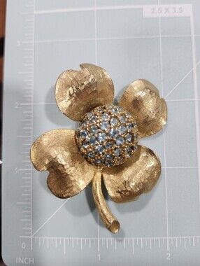 Hobé gold-tone textured Dogwood flower Brooch With Blue Rhinestone Domed Center